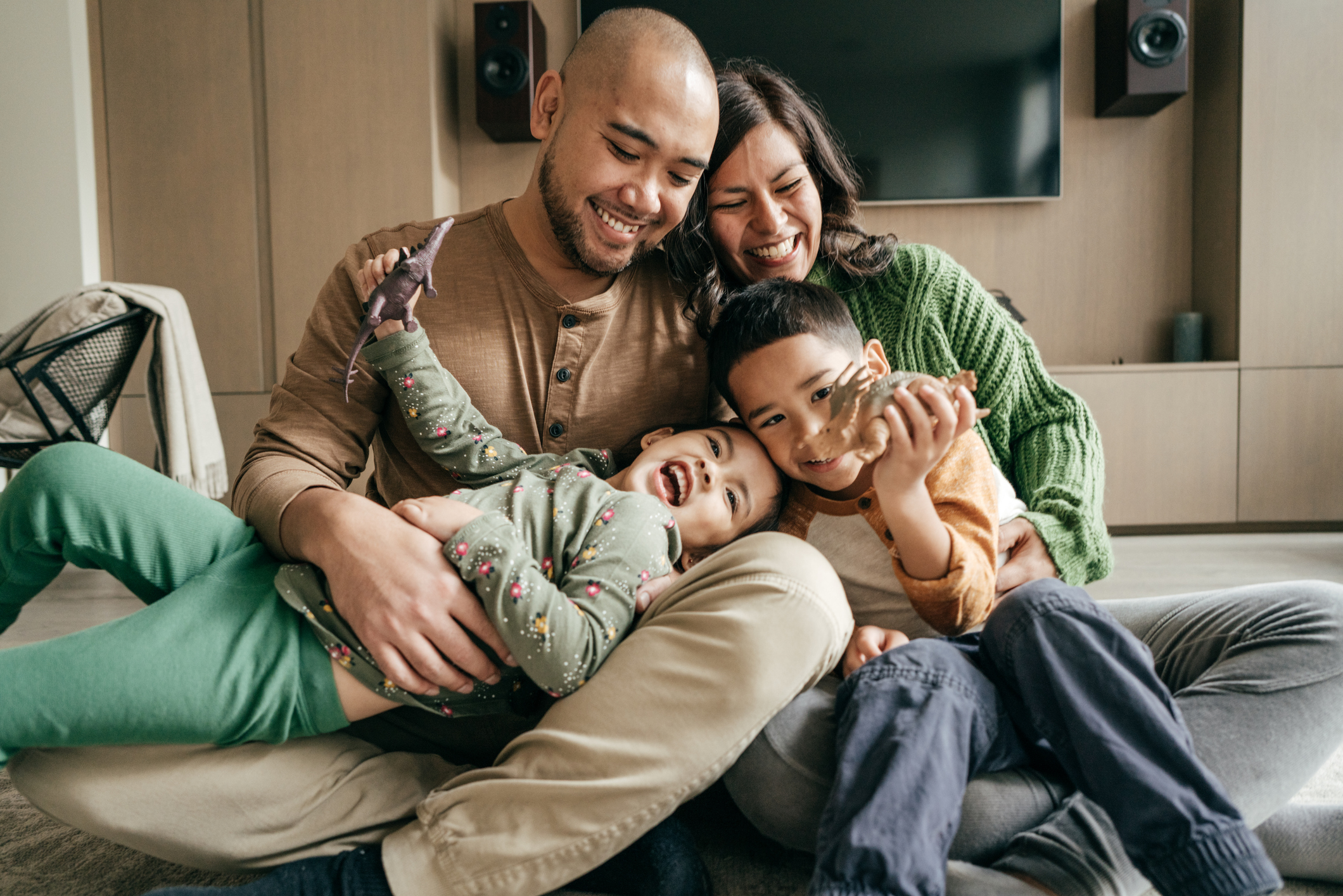 Photo of parents holding happy children