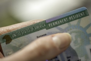 Close up view of Fragment of Permanent resident card (Green) card of USA on blurred background.