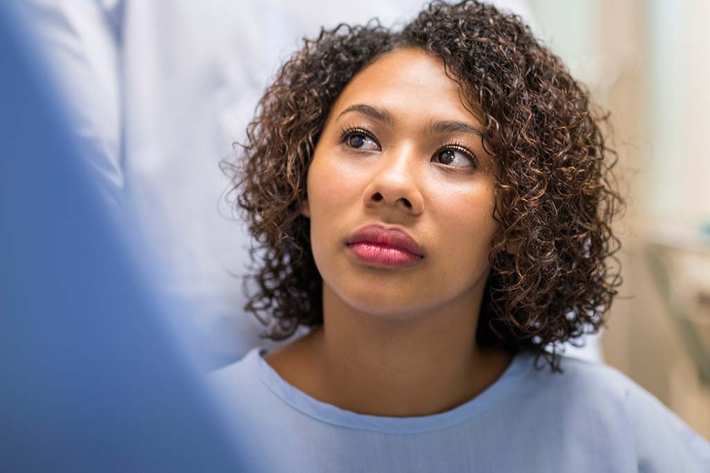 woman in examining room looking up