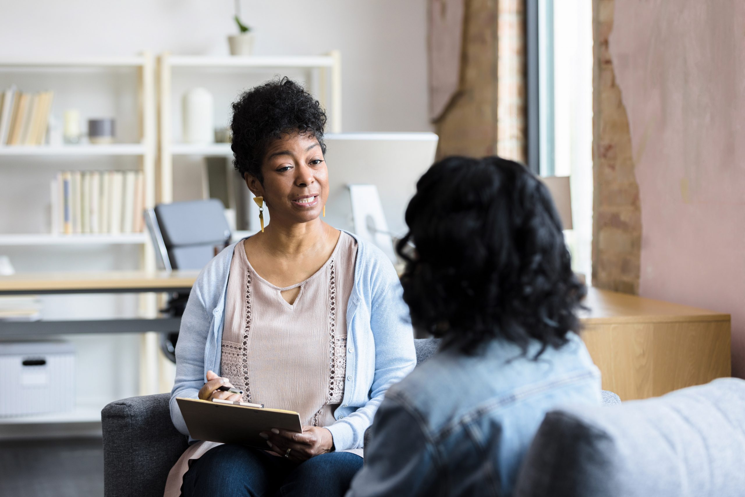 Social Worker talking with client about risky alcohol use.